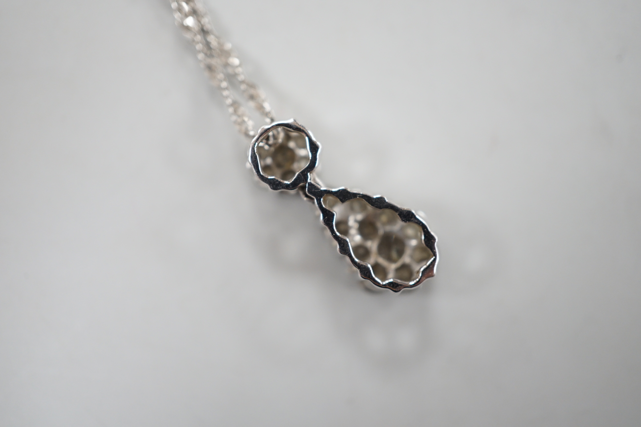 A modern 14kt white metal and pave set diamond set pear shaped pendant necklace, 52cm, gross weight 4.2 grams.
